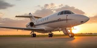 Luxurious private jet on ramp at sunset